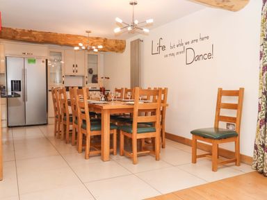 A dining room with a large table and chairs at Swallows Reach Halwell