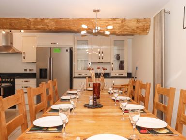 A dining room with a large table and chairs at Swallows Reach in Halwell