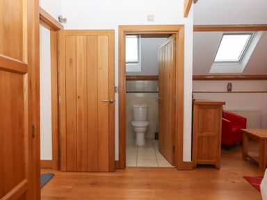 A hallway with doors leading to a bathroom at Swallows Reach Halwell