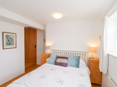A bedroom with a double bed with pillows and bedside tables with lamps at The Barn - Poplar Farm in Lower Dunsforth near Boroughbridge