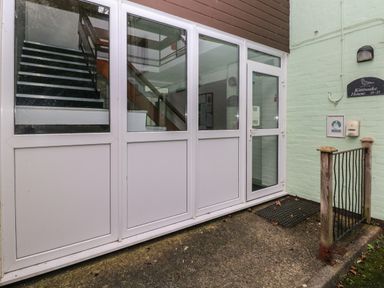 Entrance door with glass panels showing an indoor staircase at Kittiwake House Little Haven near Broad Haven