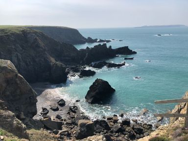 A rocky coastline with cliffs and blue sea water at Kittiwake Apartment 22 in Little Haven near Broad Haven