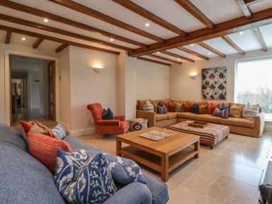 A living room with sofas and a wooden coffee table at Blossom Hill near Witney