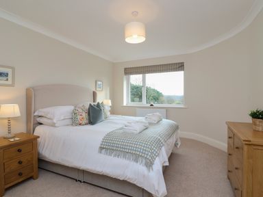 A bedroom with a bed and bedside table lamps at Blossom Hill near Witney