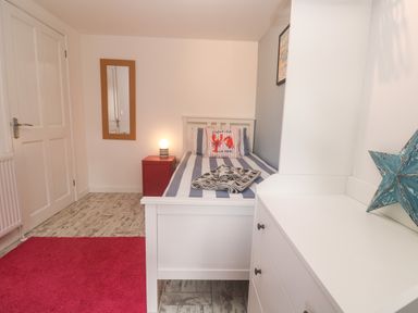A bedroom featuring a bed with pillows and blanket at The Packing House in Rosudgeon
