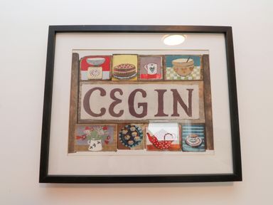 A framed artwork with kitchen items and decorations at Flat 1 Rhos-On-Sea