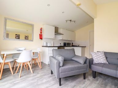 A kitchen with a dining table and chairs at H2 Atlantic Bay Holiday Park Padstow
