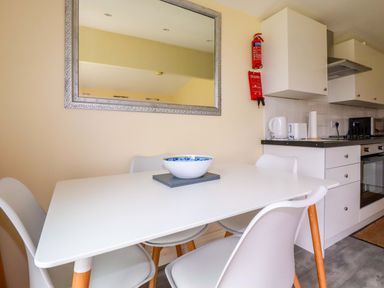 A kitchen with a table and chairs at H2 Atlantic Bay Holiday Park Padstow