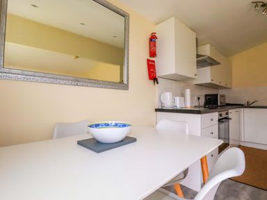 A kitchen with table and chairs at H2 Atlantic Bay Holiday Park in Padstow