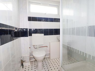 A bathroom with a toilet and shower at H2 Atlantic Bay Holiday Park, Padstow