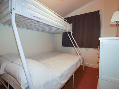 A bedroom with a bunk bed and a dresser at 161 Atlantic Bay Holiday Park in Padstow