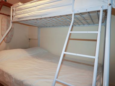 A bunk bed with a ladder in a bedroom at 161 Atlantic Bay Holiday Park, Padstow
