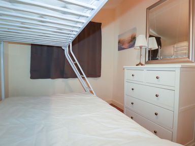 A bedroom with a bunk bed and dresser at 161 Atlantic Bay Holiday Park in Padstow