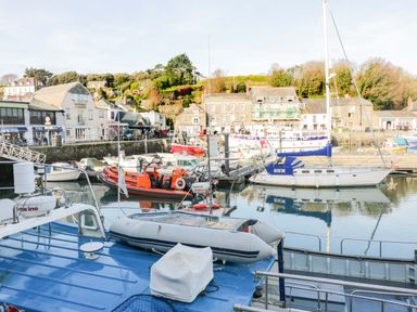 A harbor with boats moored and buildings in the background at 161 Atlantic Bay Holiday Park, Padstow