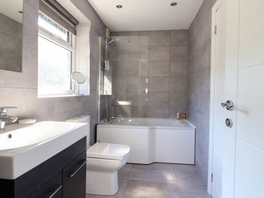 A bathroom with a sink vanity unit toilet bathtub and window at Dola in Pentre Du near Betws-Y-Coed