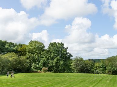 A grassy field with two small soccer goals and two people near one goal at Towy Cottage Cardigan Near Cenarth