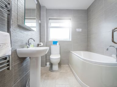 A bathroom with a sink toilet bathtub and window at Gwaun Cottage Cardigan Near Cenarth