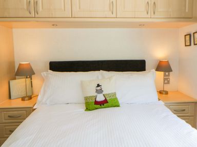 A bedroom with a bed and decorative pillow at Erisa in Stepaside