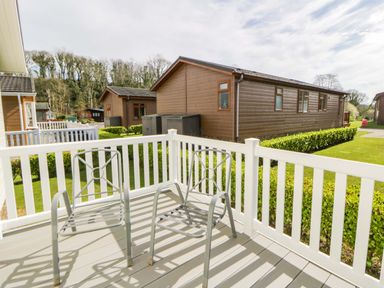 An outdoor area with chairs on a deck at Erisa in Stepaside