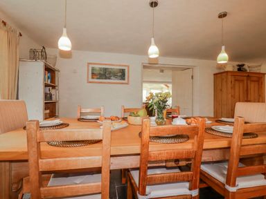 A dining room with a wooden table and chairs at Poldue House Watergate near Camelford