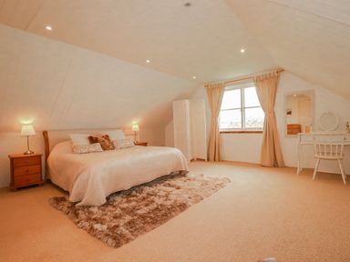 A bedroom with a bed and dressing table at Poldue House Watergate near Camelford