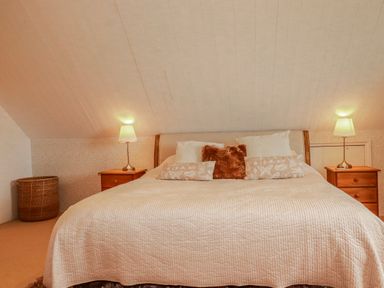 A bedroom with a bed and bedside tables at Poldue House near Watergate near Camelford