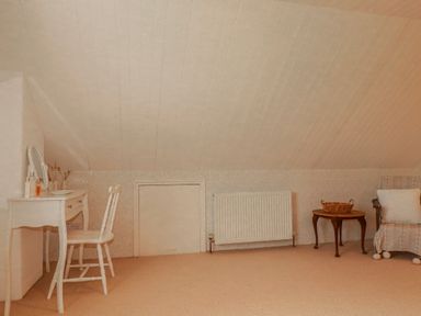 An attic with a vanity table and chair at Poldue House Watergate near Camelford