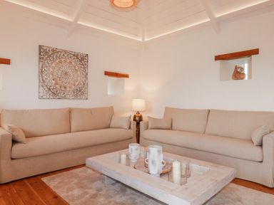 A living room with sofas and a coffee table at Logan Barn in Poldue near Camelford