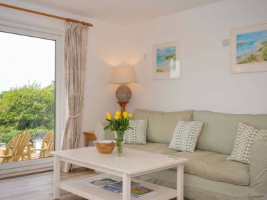 A living room with a couch and a coffee table at Seaworthy in Daymer Bay