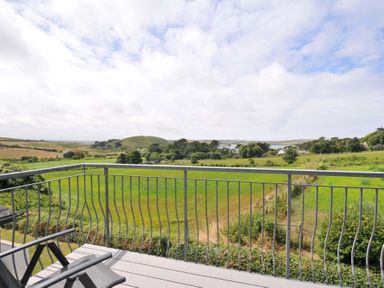 A balcony view of fields and hills at Seaworthy in Daymer Bay
