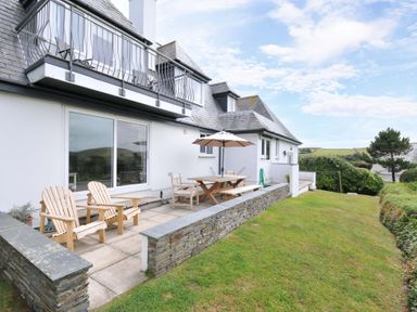 An outdoor seating area with table and chairs at Seaworthy in Daymer Bay