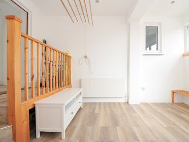 A room with a railing, radiator, bench and window at Seaworthy Daymer Bay