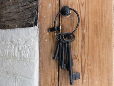 A close up of old metal keys hanging on a hook on a wooden door at Amy Cottage in West Lulworth