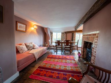 A living room with a sofa and dining table at 5 St. Michaels Close Framlingham