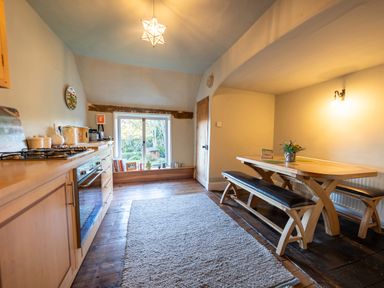 A kitchen with dining table and bench seating at 5 St. Michaels Close in Framlingham