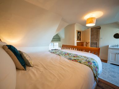 A bedroom with a bed and a window at 5 St. Michaels Close Framlingham