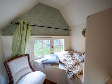 A snug area with a window seat and an armchair at 5 St. Michaels Close Framlingham
