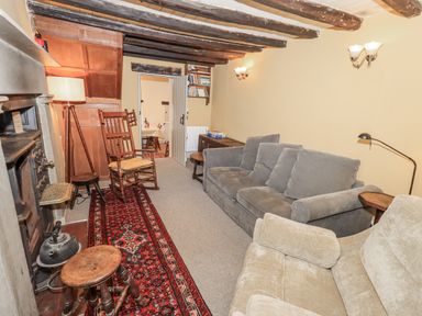 A living room with a sofa and armchair at Old Cottage in Oxen Park near Ulverston