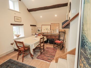 A dining room with a table and chairs at The Old Cottage in Oxen Park near Ulverston