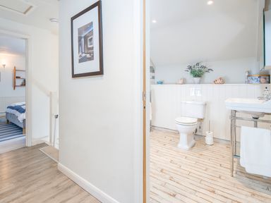 A hallway showing a bedroom on the left and a bathroom on the right at Leeward Cottage in Cosheston near Pembroke Dock