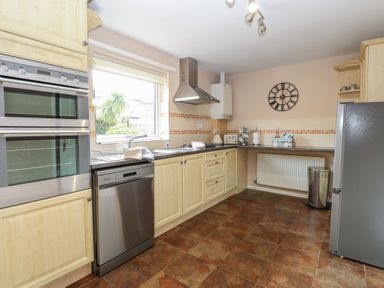A kitchen with built-in oven dishwasher fridge and countertop appliances at White Lion Retreat in Cromer