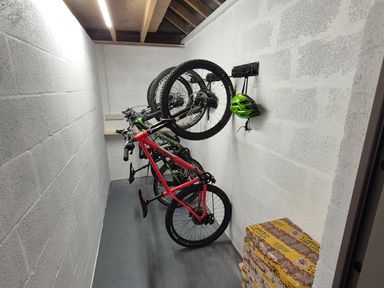 A storage room with bicycles mounted on the wall at Bramble Cottage Thornthwaite near Braithwaite