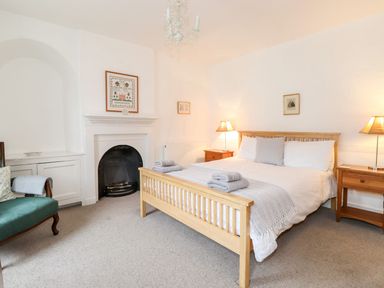 A bedroom with a wooden bed and two bedside tables with lamps at Middletown in Keswick