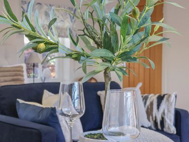 A living room with a plant and two empty glasses on a table at Providence Court Near Easingwold