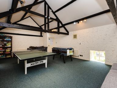 A game room with a ping pong table and foosball table at Primula Patch, Akeld near Wooler
