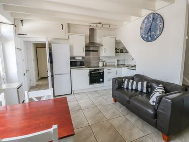 A kitchen with appliances and seating at Brynmorfa in Llandysul