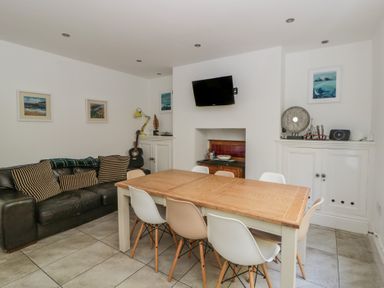 A dining room with a table and chairs at Brynmorfa in Llandysul