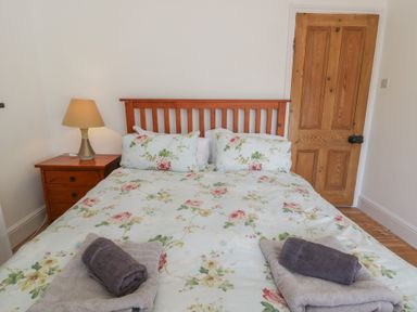 A bedroom with a bed and bedside table at Brynmorfa in Llandysul