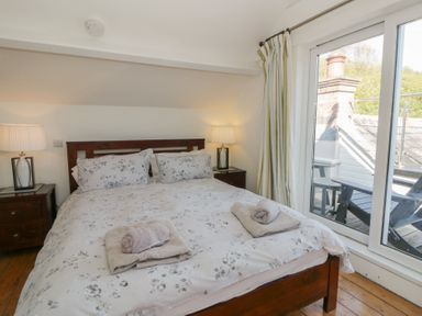 A bedroom with a bed and bedside tables at Brynmorfa in Llandysul