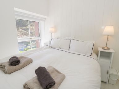 A bedroom with a bed and nightstand at Brynmorfa in Llandysul
